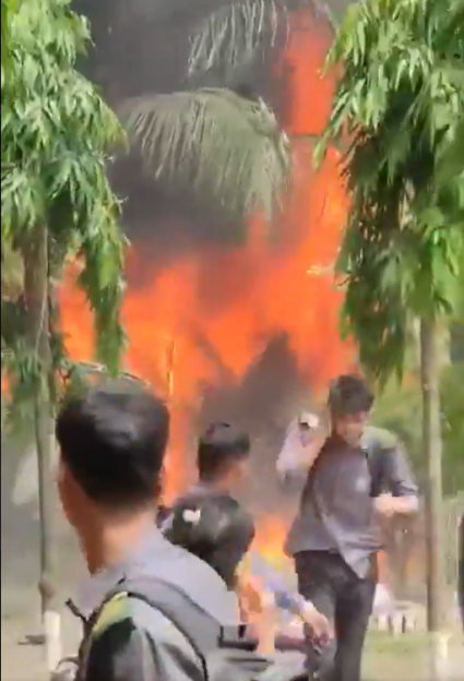 People watching a large fire.