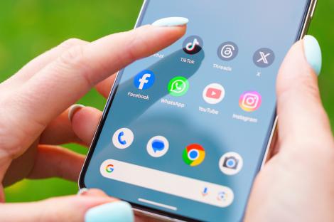 Close-up of a person using a Google Pixel smartphone to select an app.