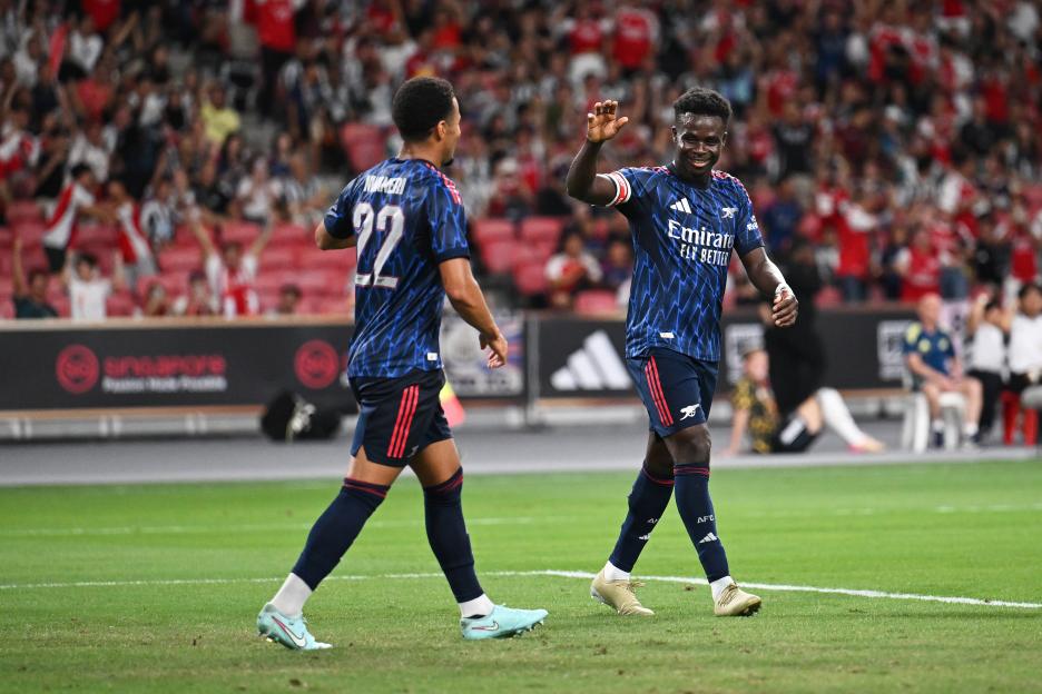 Bukayo Saka and Ethan Nwaneri of Arsenal celebrating a goal.