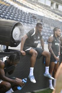 Chelsea soccer players cooling down with a fan after training.