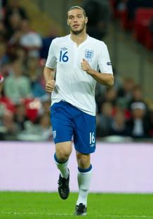 Andy Carroll, number 16, playing for England.