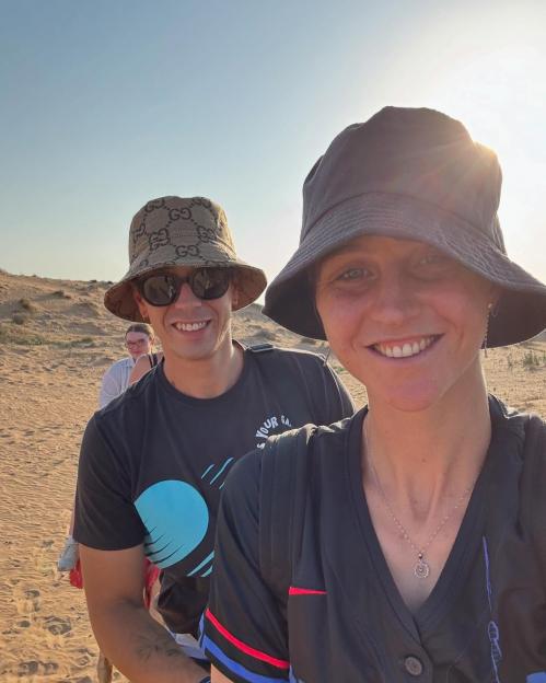 Selfie of two people in a desert setting.