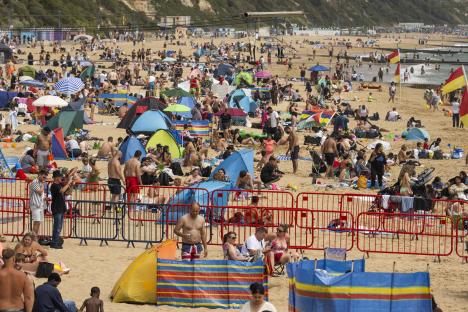 Crowded Bournemouth beach on a hot day.