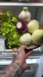 Lettuce, onions, and garlic in a bowl.