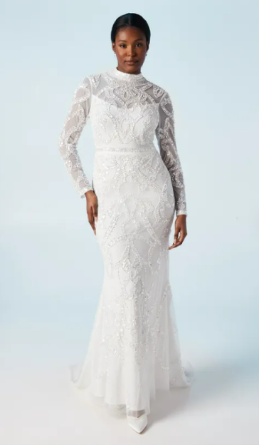 Woman in beaded white gown.