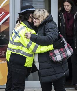 Lisa Squire, mother of missing student Libby Squire, hugs a police officer.