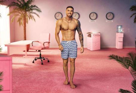 A shirtless man in swim trunks stands in a pink office with palm trees.