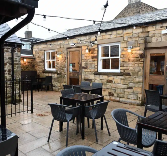 Outdoor patio seating area of the Horse Shoe Inn in Crook.
