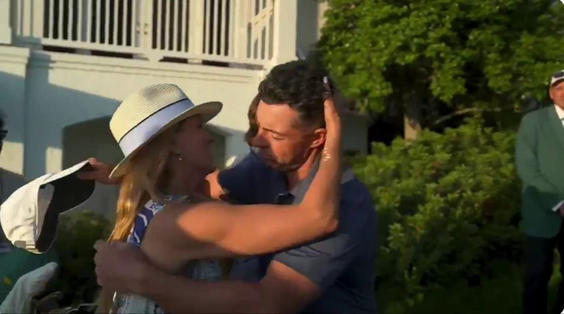 Rory McIlroy embracing Justin Rose's wife, Kate.