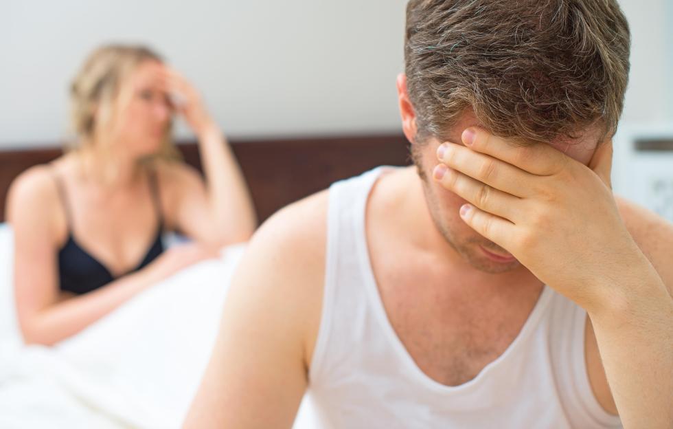 Upset couple in bed.