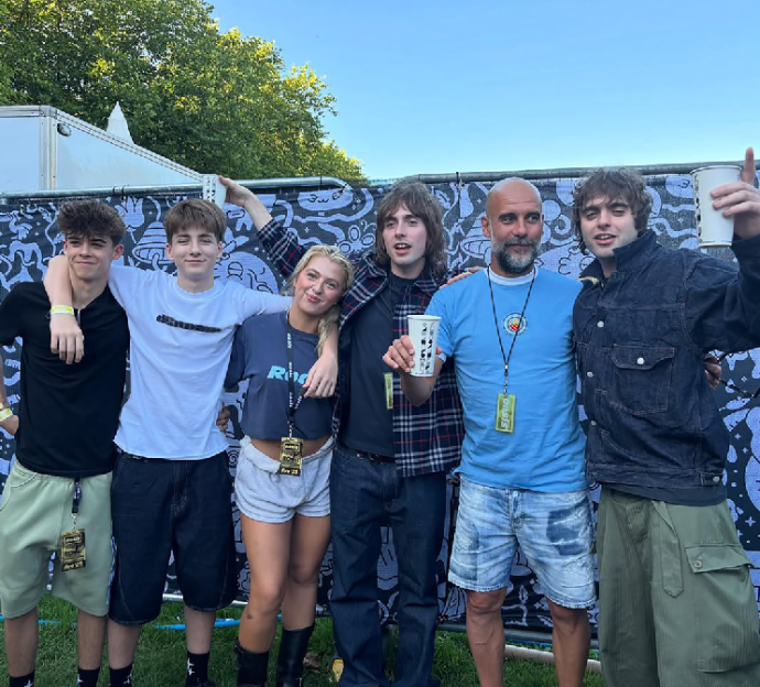 Group photo of six people at a festival.