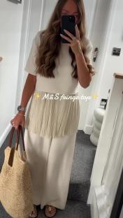 Woman modeling an M&S fringe top and wide-leg pants.
