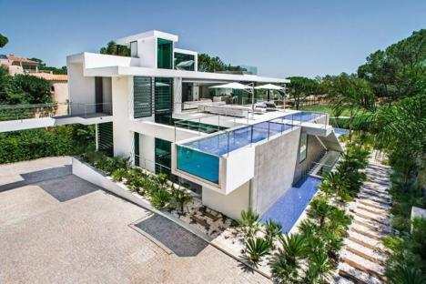 Modern luxury villa with infinity pools and landscaped gardens.
