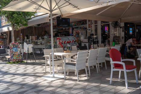 Empty tables and chairs at an outdoor cafe in Magaluf.