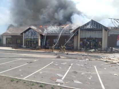 Firefighters battling a fire at a burning building.