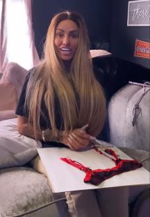 Woman selling framed lingerie.