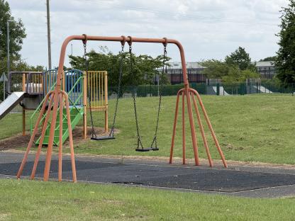 Empty swings and playground equipment.