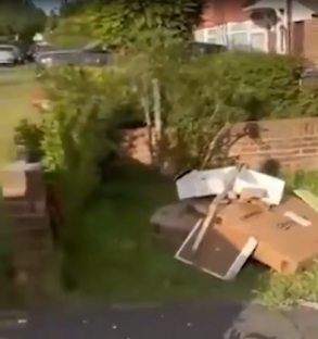Pile of rubbish dumped on a lawn.