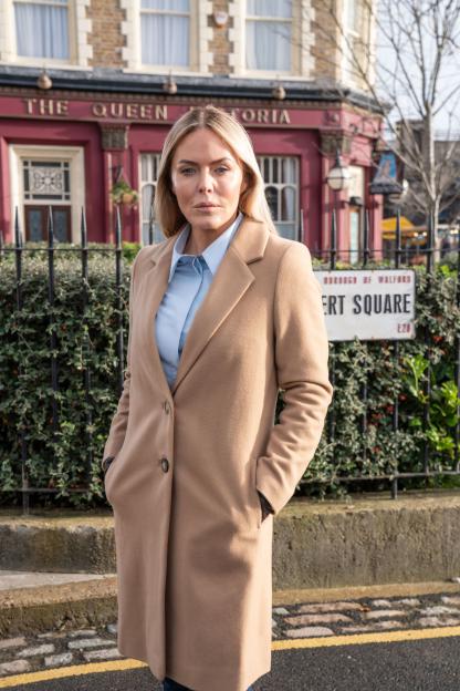 Patsy Kensit in a camel coat outside The Queen Victoria pub.