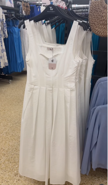 White sleeveless midi dress on a hanger.