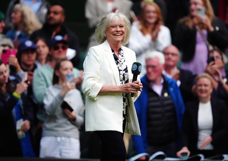 Sue Barker holding a microphone at Wimbledon.