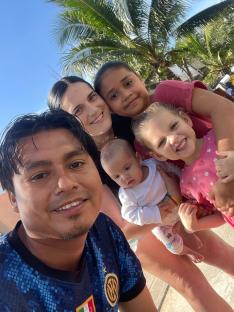 Family selfie with three children and two adults.