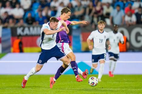 Elliot Anderson and Jack Hinshelwood battling for the ball during a soccer match.