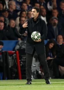 Mikel Arteta, Arsenal manager, holding a Champions League ball.