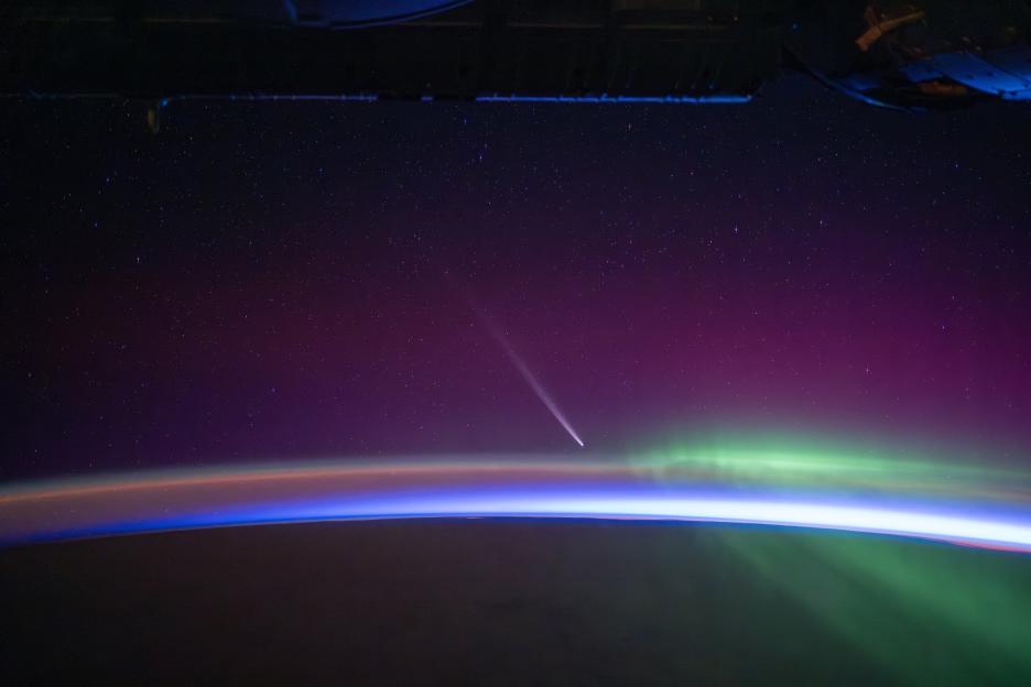 the aurora borealis is visible in the night sky above the earth