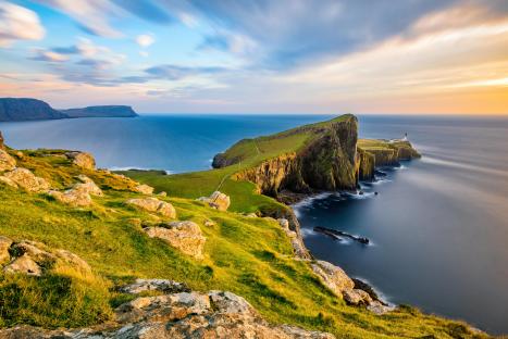 British coastline at sunset with lighthouse.