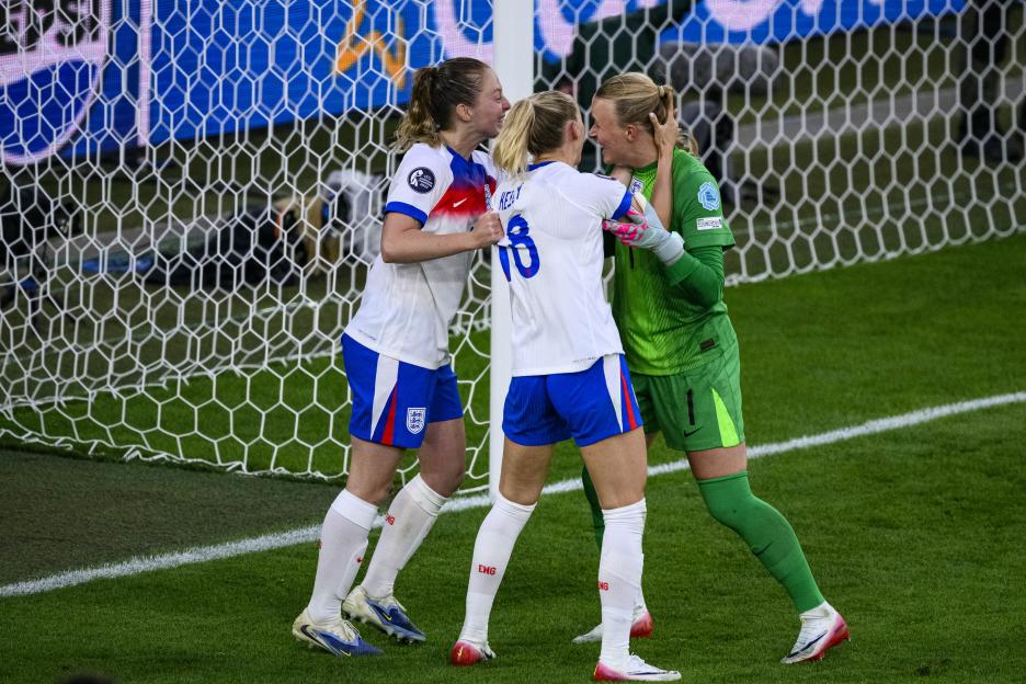 England's Chloe Kelly celebrates with teammates after winning a penalty shootout.