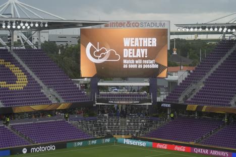 Stadium scoreboard announcing a weather delay.