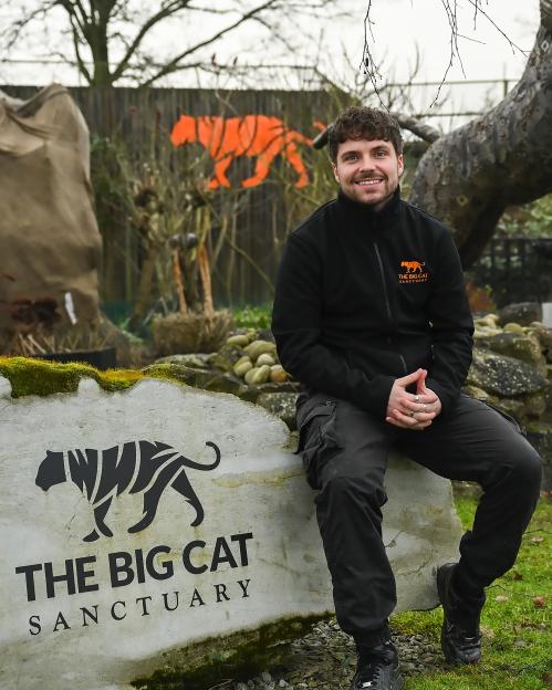 Man sitting on a rock at The Big Cat Sanctuary.
