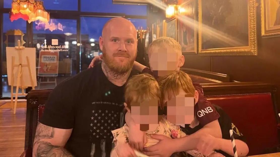 Photo of Lenny Scott with his children.