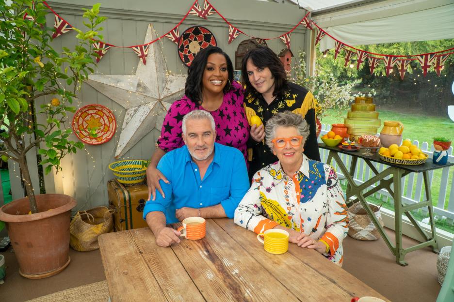 Danny Dyer, Leigh Francis, Rhod Gilbert, and Yinka Bokinni with Prue Leith and Paul Hollywood on the Great British Bake Off.