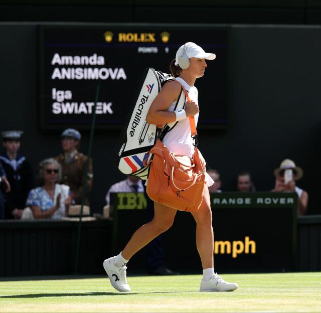 Iga Swiatek walking onto Centre Court at Wimbledon.