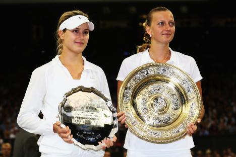 Petra Kvitova and Eugenie Bouchard holding the Wimbledon Ladies' Singles trophies.