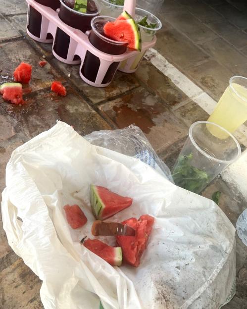 Photo of watermelon and drinks prepared in unsanitary conditions.