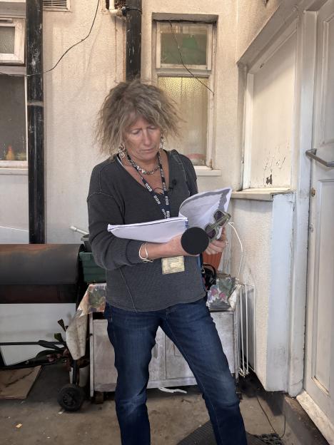 BBC journalist Sue Mitchell reviewing documents.