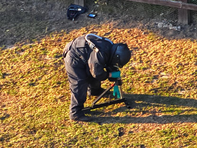 Bomb disposal expert working on an explosive device.