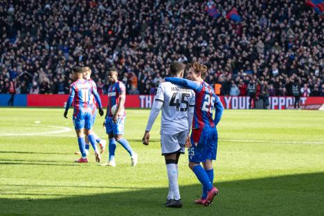 Two soccer players embracing on the field.