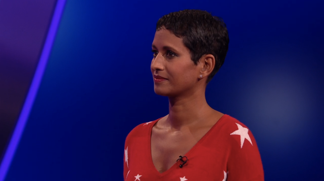 Woman in red star-print sweater against a blue background.