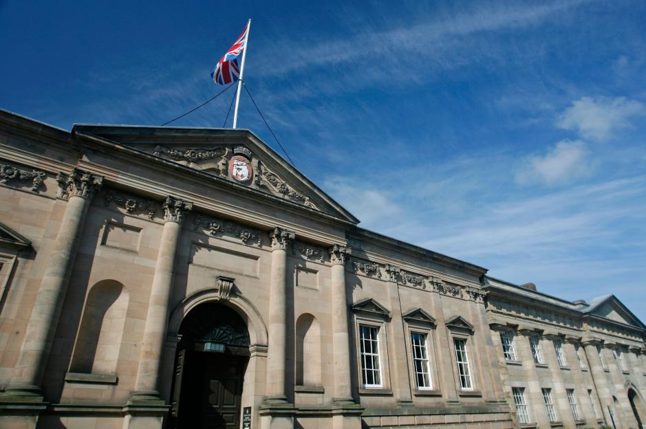 Warwick Crown Court building with a Union Jack flag flying.