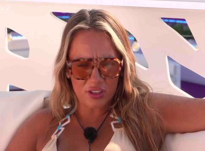 Woman wearing sunglasses speaks.