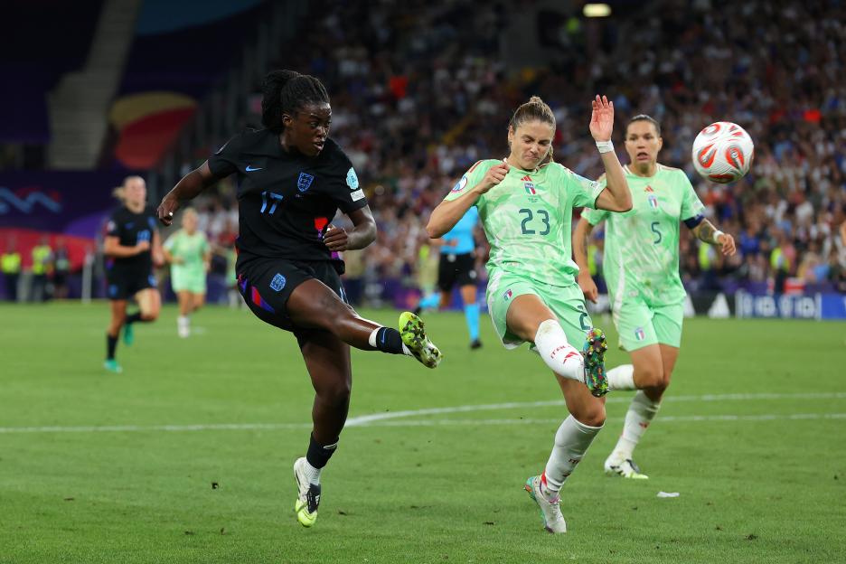 Michelle Agyemang of England kicks the ball past Cecilia Salvai of Italy during a soccer match.