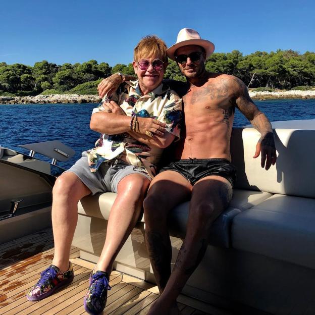 Elton John and David Beckham on a boat.