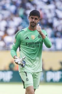 Thibaut Courtois of Real Madrid giving a thumbs up.