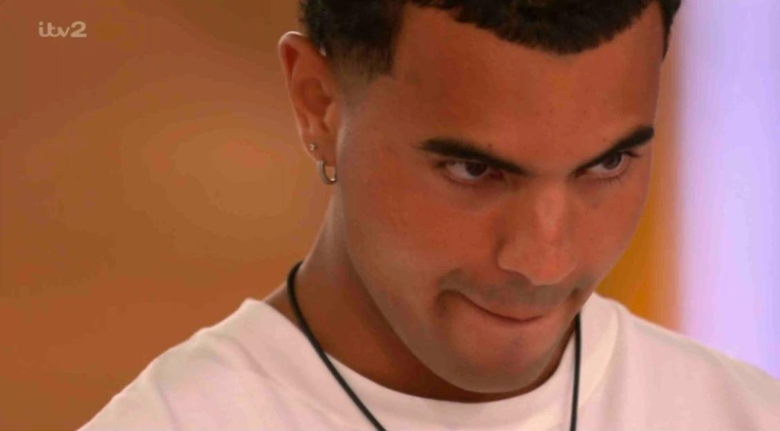 Close-up of a man looking down.
