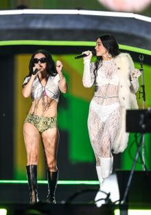 Charli XCX and Dua Lipa performing on stage.