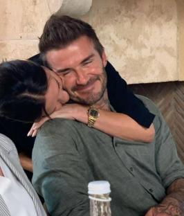 David Beckham being embraced by someone.